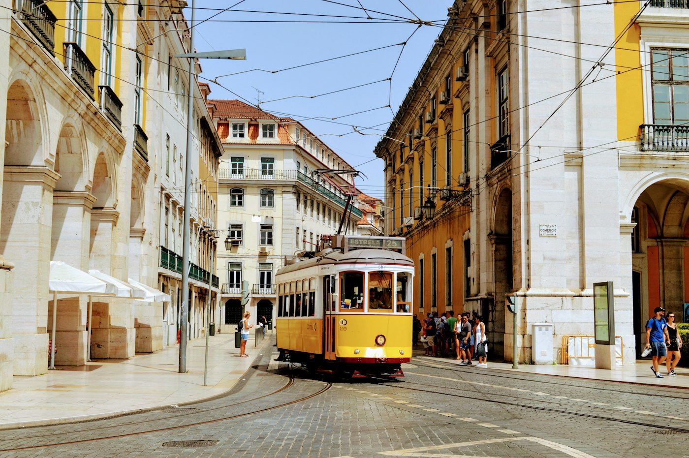 Yellow tram on a sunny street in Lisbon, Portugal