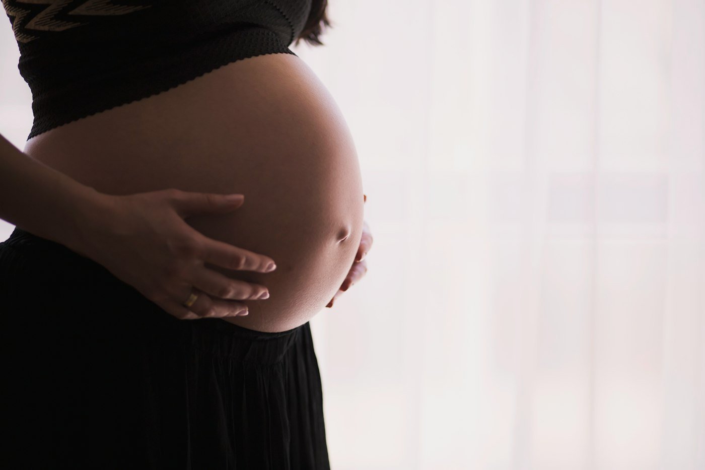 Expectant mother holding her baby bump
