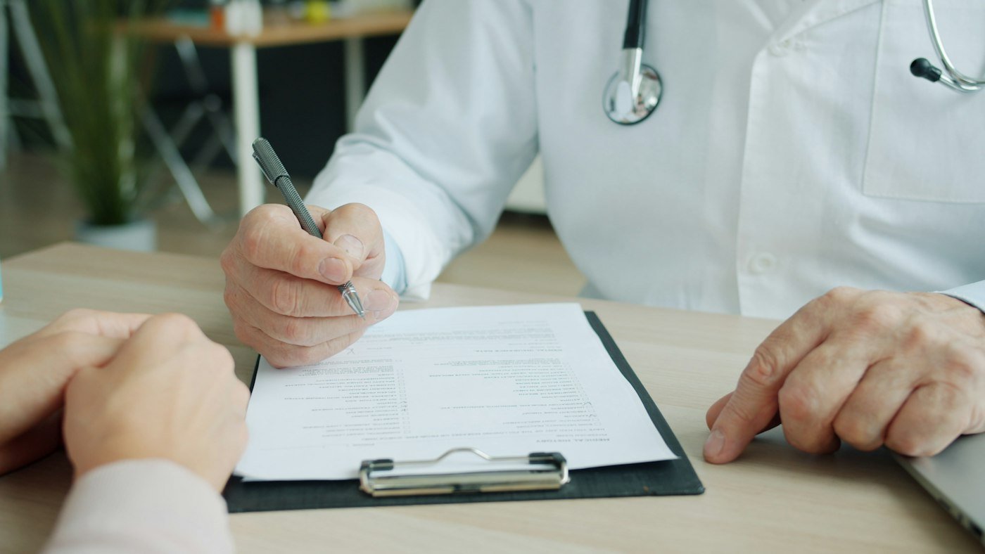 Doctor noting a patient's medical history during an appointment
